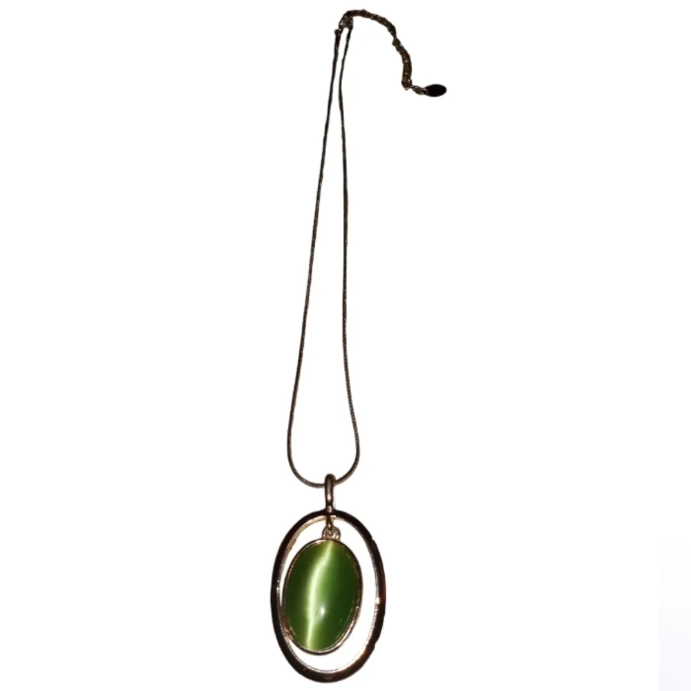Claire's silver necklace with a green cat's eye pendant